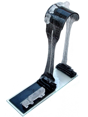 The strength of the thin glass supports the hill on top...