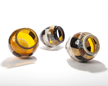 A first foray into the world of roll ups in the hotshop, using fused slabs of honeycomb, refired full of contrasting glass colours...