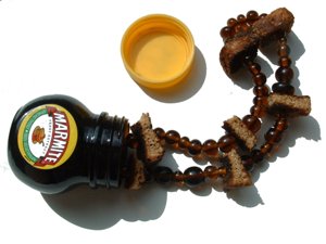 Marmite beads come pouring out of the tiny glass jar...