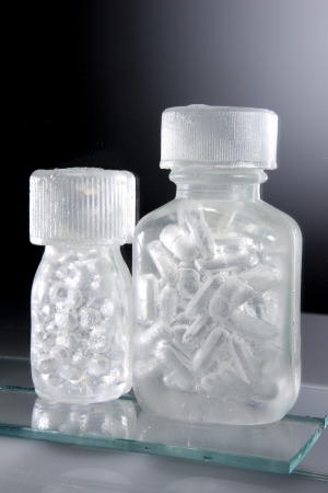 Detail showing 2 of the pill bottles with the image of the pills created by the hollow cavity in the glass, so made of nothing at all...