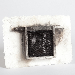 Cast cotton paper encases the dark glass honeycomb in this macabre piece...