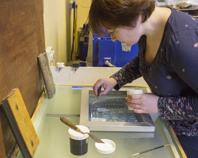 Rachel, printing onto glass in her studio.